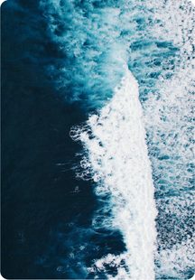 Foaming wake trailing through deep blue water