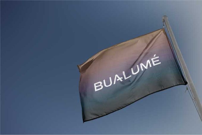 Bualume flag moving against a clear blue sky