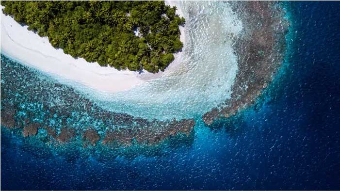 Aerial surf and island coastline